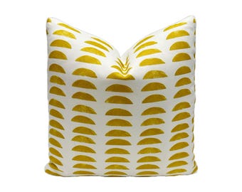 May include: White throw pillow with a geometric pattern of yellow half-circles.