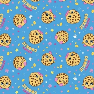 May include: A repeating pattern on a blue background featuring cartoon cookies with smiling faces, pink bows, and brown chocolate chips. The word "KOOKY COOKIE" is written in a pink font. The design includes stars and coin shapes.