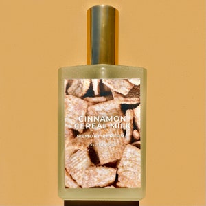 May include: A glass bottle of cinnamon cereal milk scented perfume by Colornoise. The label features a close-up image of cinnamon cereal squares and the text "Cinnamon Cereal Milk Memory Perfume Colornoise".