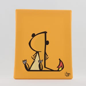 May include: An orange canvas print featuring a cartoon dinosaur illustration. The dinosaur is drawn with black outlines and has a yellow body with red and yellow accents. The dinosaur is sitting down with its back to the viewer.