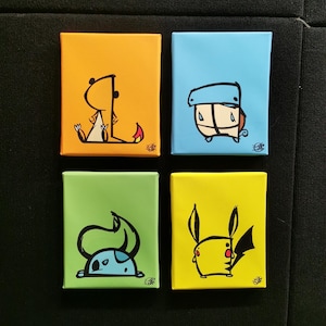 May include: Four small square canvas paintings with cartoon character illustrations. Each canvas has a different solid color background: orange, blue, green, and yellow. The cartoon characters are outlined in black with some color details.