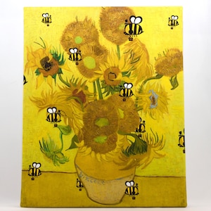 May include: A canvas print of Van Gogh's "Sunflowers" painting, with cartoon bees superimposed on the yellow background. The sunflowers are in a yellow vase, and the bees are black and yellow.