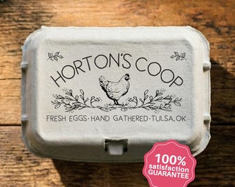 May include: A light gray molded pulp egg carton featuring a black printed design with a central chicken illustration, floral accents, and the text HORTON'S COOP, FRESH EGGS, HAND GATHERED, TULSA, OK. A pink scalloped badge displays 100% SATISFACTION GUARANTEE.
