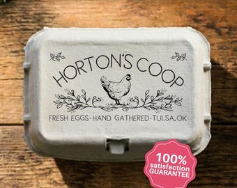 May include: A light gray molded pulp egg carton featuring a black printed design with a central chicken illustration, floral accents, and the text HORTON'S COOP, FRESH EGGS, HAND GATHERED, TULSA, OK. A pink scalloped badge displays 100% SATISFACTION GUARANTEE.