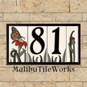 May include: Rectangular house number tile with the numbers "81" in black. A butterfly rests on a red flower with green leaves. The tile is framed in black and the text "MalibuTileWorks" is at the bottom.