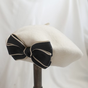 Classic French-Inspired White Beret with Delicate Black Bow Accent