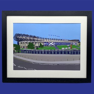 May include: A framed illustration of a large stadium with a blue and white color scheme. The stadium is called "BT Murrayfield" and is surrounded by a green field. The illustration is set against a blue sky.
