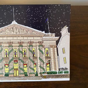 May include: A snowy night scene with a large building decorated with evergreen garlands and nutcracker figures in the windows. The building has a classical architectural style with columns and a decorative cornice.