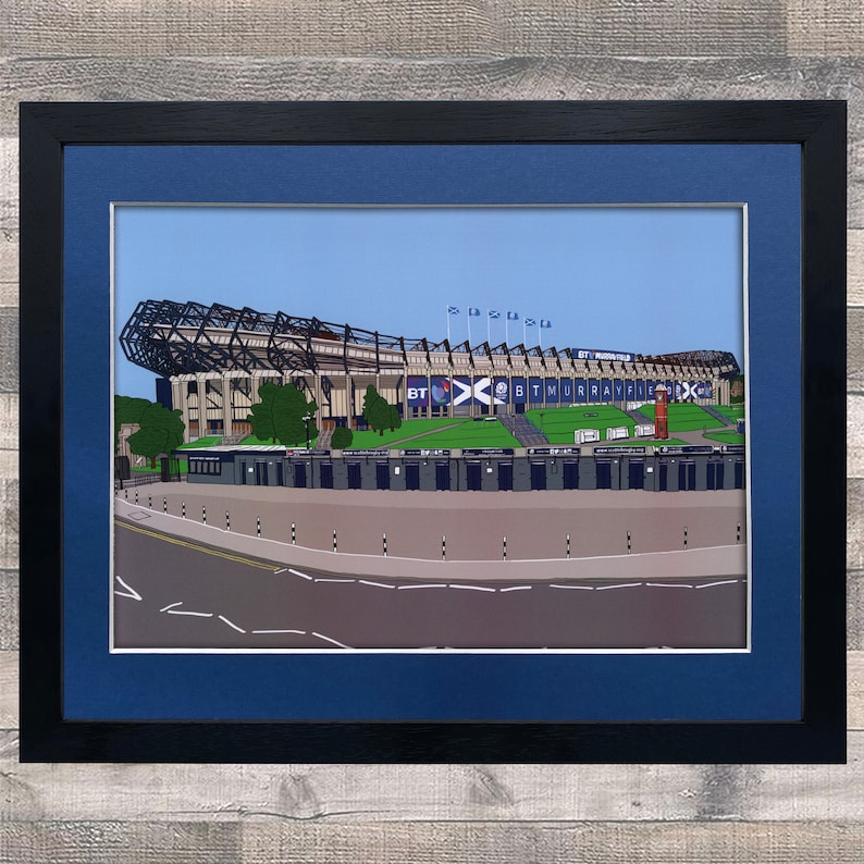 May include: A framed illustration of a large stadium with a blue and white color scheme. The stadium is surrounded by a green field and a road. The text "BT Murrayfield" is visible on the stadium.