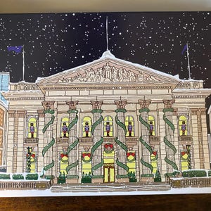 May include: A snowy night scene with a large building decorated with greenery and lights. The building has a classic architectural style with columns and a pediment. There are small figures in the windows that look like nutcrackers.