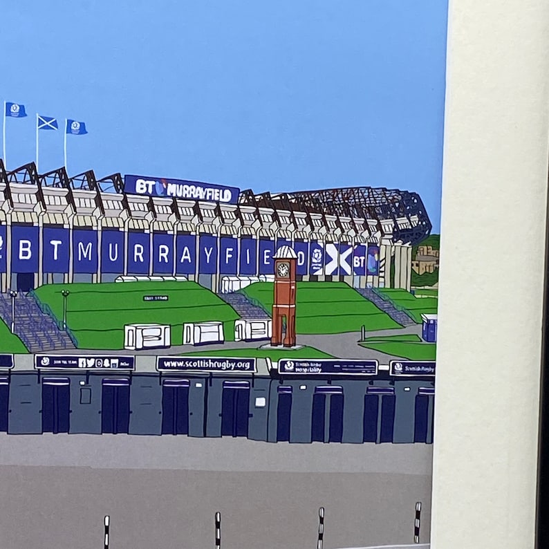 May include: A colorful illustration of a stadium with a clock tower and the text "BT Murrayfield" on the side. The stadium is surrounded by a green lawn and a blue sky.