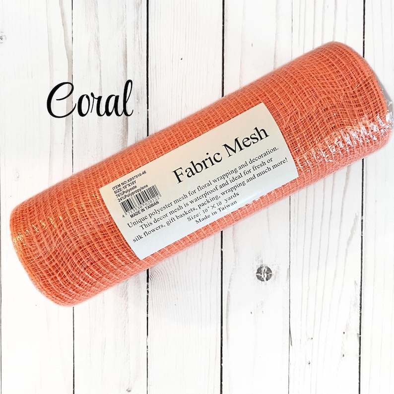 May include: A roll of coral-colored fabric mesh for floral arrangements and decoration. The label reads "Fabric Mesh" and indicates it's waterproof, ideal for fresh or silk flowers, gift baskets, and wrapping. The mesh measures 10 x 10 yards.
