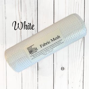 May include: A roll of white fabric mesh for floral wrapping and decoration. The label reads "Fabric Mesh" and mentions it is waterproof and ideal for fresh or silk flowers, gift baskets, and more. The size is 10 x 10 yards.