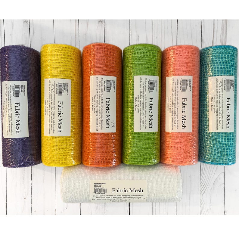 May include: A collection of colorful fabric mesh rolls in various shades, including purple, yellow, orange, green, coral, and teal. A white roll of fabric mesh is also present. Each roll has a label that reads "Fabric Mesh".