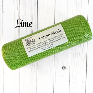 May include: A roll of lime green fabric mesh for floral wrapping and decoration. The label reads "Fabric Mesh" and mentions it is waterproof. The roll is 10" x 10 yards. The word "Lime" is written in cursive in the upper left corner.