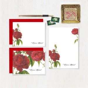 May include: Set of personalized stationery featuring a floral design with red roses and green leaves. The stationery includes note cards and envelopes with the name "Claire Mitchell" printed on each piece.