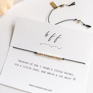 May include: A black string bracelet with gold beads and a gold tag that says "lovassion". The bracelet has a card attached to it that says "bff" and "Because of you I laugh a little harder, cry a little less, and smile a lot more." The card also has the website address www.lovassion.etsy.com.