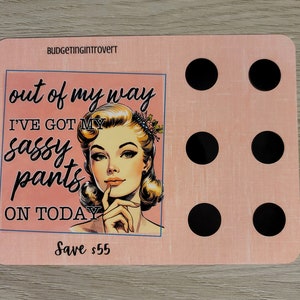 May include: Pink and white motivational quote card with a retro illustration of a woman with a sassy expression. The text reads "out of my way I've got my sassy pants on today" and "Save &pound;55".
