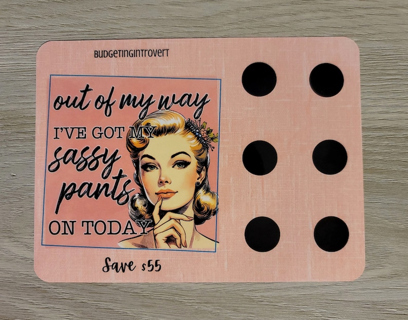 May include: Pink and white motivational quote card with a retro illustration of a woman with a sassy expression. The text reads "out of my way I've got my sassy pants on today" and "Save &pound;55".