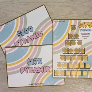 May include: Two printable $300 and $175 pyramid savings challenge trackers with rainbow stripes and gold circles. The text "Budgetingintrovert" is at the bottom of each tracker.