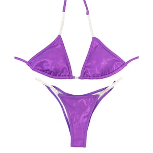 May include: Purple sparkly bikini with crystal embellishments on the straps.