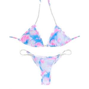 May include: A blue and pink tie-dye bikini with a rhinestone strap detail.
