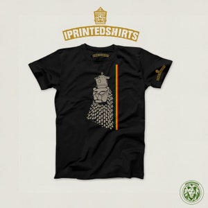 May include: Black t-shirt with a graphic of a lion's head with a crown on top. The lion's head is made up of small squares. The graphic is on the left side of the shirt, and a red, yellow, and green stripe is on the right side of the shirt.