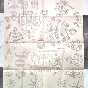 May include: A black and white printable pattern sheet with various Christmas-themed illustrations, including a gingerbread house, a Christmas tree, snowflakes, ornaments, and a gingerbread person. The text "Baking Spirits Bright" and "Let it Snow" are included in the design.