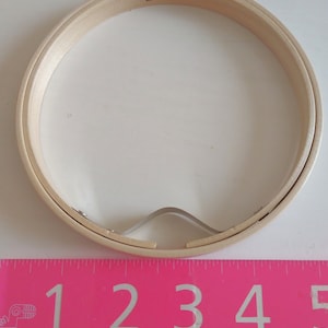 May include: A wooden embroidery hoop with a 12cm diameter. The hoop is made of natural wood and has a metal tightening mechanism.