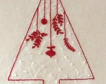 May include: Red embroidered Christmas tree with white dots and red ornaments hanging from the branches.