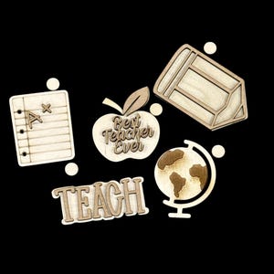 May include: Wooden cutouts of school-themed items, including a notepad with an "A" grade, a pencil, an apple with "Best Teacher Ever" text, a globe, and the word "TEACH". The cutouts are light brown.