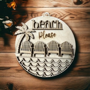 May include: A round wooden sign with the text "beach please" and a palm tree with four chairs on a beach. The sign is made of wood and has a natural finish.