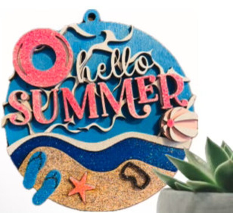 May include: Round wooden sign with the text "hello summer" in pink and blue lettering. The sign features a beach scene with a blue ocean, sand, flip flops, a starfish, and a beach ball.