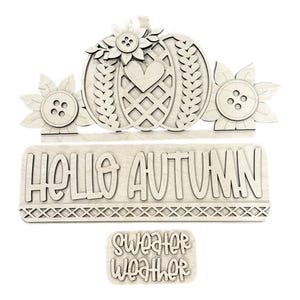May include: Wooden autumn-themed decor featuring a pumpkin with sunflower accents and the phrase "HELLO AUTUMN." Includes a separate piece with "SWEATER WEATHER" text. Perfect for fall decorating.