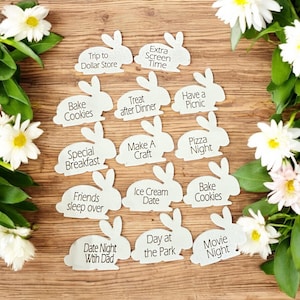 May include: White felt bunny shapes with different activities written on them, such as "Bake Cookies", "Pizza Night", "Ice Cream Date", and "Movie Night".