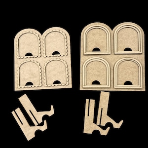 May include: Two sets of unfinished wooden picture frame cutouts with arched openings and scalloped edges. Each set has four openings. Separate wooden stands are included for display. The items are set against a black background.