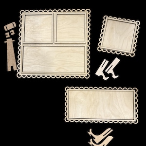 May include: A collection of unfinished wooden frames and decorative elements. The frames have scalloped edges and are designed to hold photos or artwork. Additional wooden cutouts are included for assembly and display.