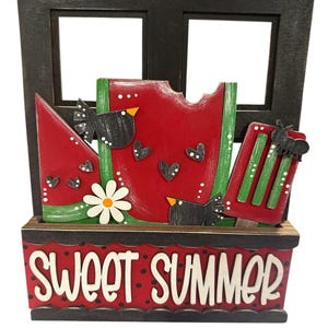 May include: A wooden summer-themed decoration featuring a black window frame. The decoration includes a watermelon slice, popsicles, and black birds. The base reads "SWEET SUMMER" in white lettering. The watermelon has black heart accents.