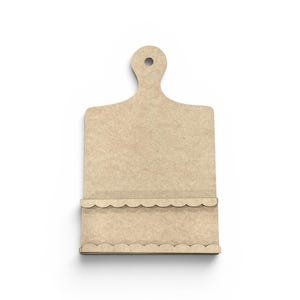 May include: A light brown, wooden cutting board with a handle and a scalloped edge. The cutting board is rectangular with a handle at the top and a shelf at the bottom. The design is simple and minimalist.
