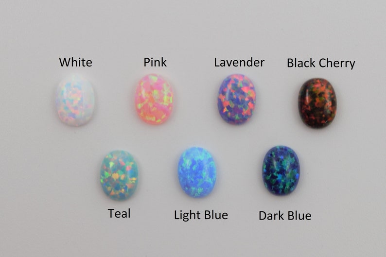 May include: Oval-shaped opal cabochons in various colors, including white, pink, lavender, black cherry, teal, light blue, and dark blue.