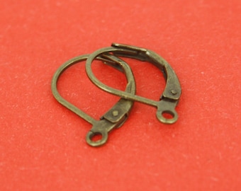 May include: Two antique gold-toned earring hooks. The hooks are made of metal and have a simple, classic design.