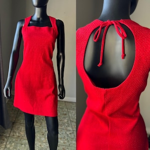 May include: A red sleeveless dress with a square neckline and a keyhole back with a tie closure.