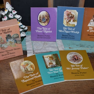 May include: A collection of ten vintage children's books by Beatrix Potter. The books feature colorful covers with illustrations of Peter Rabbit, Mrs. Tiggy-Winkle, the Tailor of Gloucester, Squirrel Nutkin, and Mr. Jeremy Fisher.