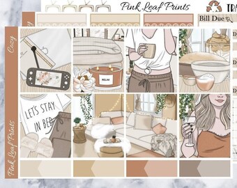 May include: A set of printable planner stickers with a cozy theme. The stickers feature illustrations of a woman drinking wine, a woman reading a book, a dog, a cup of coffee, a candle, and a television. The stickers are in shades of brown, beige, and white.