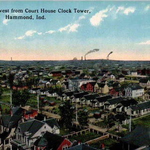 May include: A vintage postcard showing a panoramic view of Hammond, Indiana, looking northwest from the Court House Clock Tower. The scene features residential houses, green trees, and industrial smokestacks emitting smoke against a blue sky.