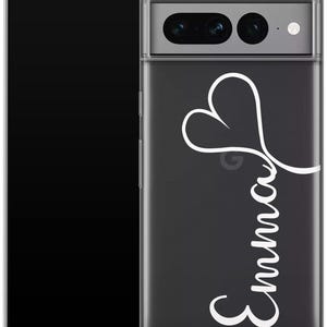 May include: A clear phone case with a black background and a white heart design. The name "Emma" is written in a cursive font below the heart. The phone case is on a black smartphone.