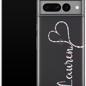 May include: A clear phone case with a black background. The case features a white heart design with a red floral pattern and the name "Lauren" in a cursive font. The phone case is designed to fit a smartphone.