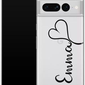May include: Clear phone case with a black heart and the name "Emma" in a cursive font. The case is on a black smartphone. The phone case has a camera cutout.