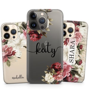 May include: Clear phone cases with floral designs and personalised names. The cases have a transparent background with a watercolour-style floral arrangement in red, pink, and white. Names "Katy", "Isabella", and "Shara" are printed on the cases.