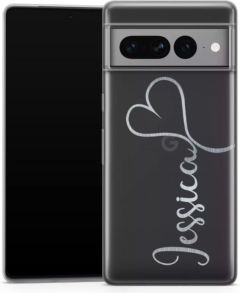 May include: A clear phone case with a black background and the name "Jessica" in a cursive font. A silver heart design is above the name. The phone case is on a black smartphone.
